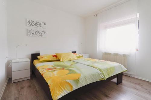 a bedroom with a large bed with yellow sheets at Pri Neji in Postojna