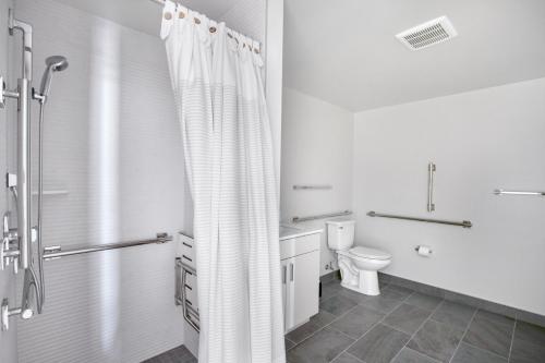 a bathroom with a shower curtain and a toilet at NoMa 1br w wd concierge gym nr Metro WDC-648 in Washington