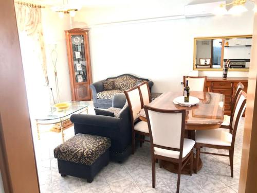 a living room with a table and a chair and a dining room at New elegant apartment in Kallithea Xalkidiki in Kallithea Halkidikis