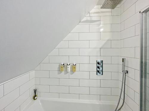 a white bathroom with a shower and a tub at ENTR - Modern Apartments in Windsor in Windsor
