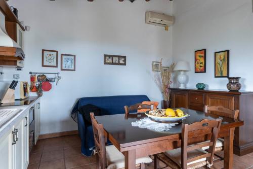 a kitchen with a table with a bowl of fruit on it at La Finestra sulle Eolie in Reitano