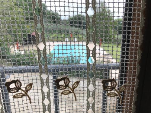 a screened in window with butterflies on a fence at Genius Loci Country Inn in Bevagna