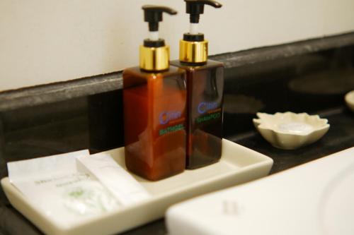 two bottles of cleaner sitting on top of a counter at Citin Pratunam Bangkok by Compass Hospitality in Bangkok