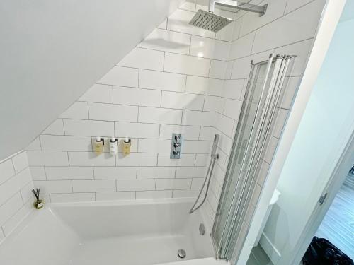 a white bathroom with a shower and a toilet at ENTR - Modern Apartments in Windsor in Windsor