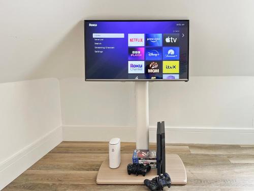 a flat screen tv on top of a wall at ENTR - Modern Apartments in Windsor in Windsor