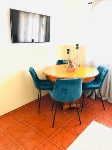 a dining room table with blue chairs in a room at Casa Da Várzea in Torres Vedras