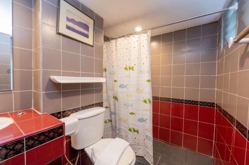 a bathroom with a toilet and a shower at Hillside Resort in Pattaya Central