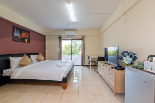 a bedroom with a bed and a flat screen tv at Hillside Resort in Pattaya Central