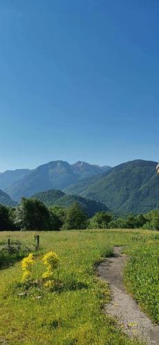 a dirt road in a field with mountains in the background at Appartement A proximité d'Ax les thermes in Ignaux