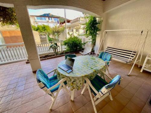 a table and chairs with a laptop on a balcony at CASA CELSA in Mongiove
