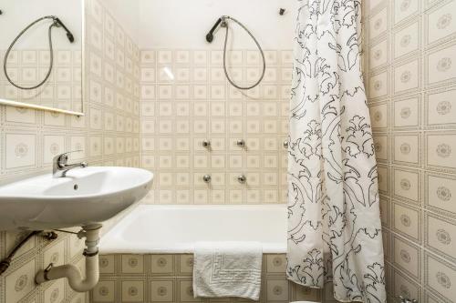 a bathroom with a sink and a shower curtain at Hostal La Marina in Platja d'Aro