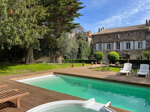 a swimming pool in the backyard of a house at Maison Riquet in Castelnaudary