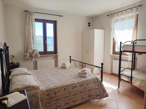 a bedroom with a bed and a window at Agriturismo L'Uliveto in Gargnano