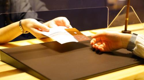 a person holding a credit card in their hands at Onn Yuda Onsen in Yamaguchi