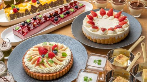 two cakes are sitting on plates on a table at Onn Yuda Onsen in Yamaguchi