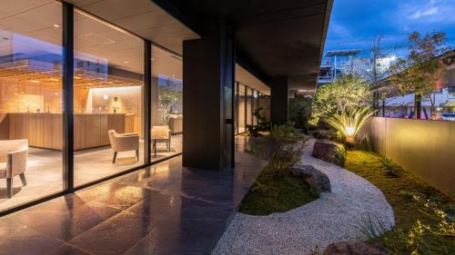 a lobby of a building with glass walls at Onn Yuda Onsen in Yamaguchi