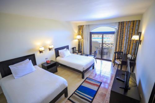a hotel room with two beds and a balcony at Blend Elphistone Resort Marsa Alam in Abu Dabab