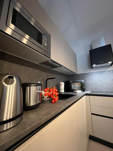 a kitchen with a stove with pots and tomatoes on the counter at Casa Zovetto in Cuneo