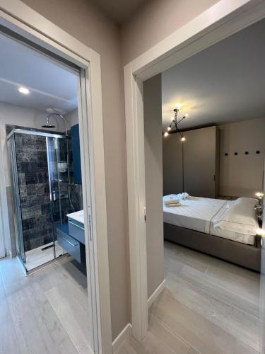 a bedroom with a bed and a bathroom with a shower at Casa Zovetto in Cuneo