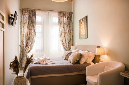 En eller flere senge i et værelse på Loggia Ηome