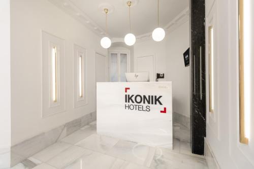a white room with a sign on a wall at Ikonik Gran Vía in Madrid