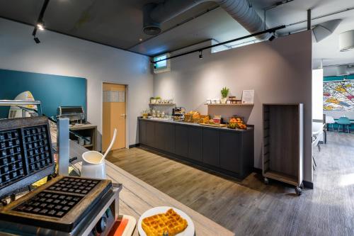 a kitchen with a counter with food on it at ibis Köln Frechen in Cologne