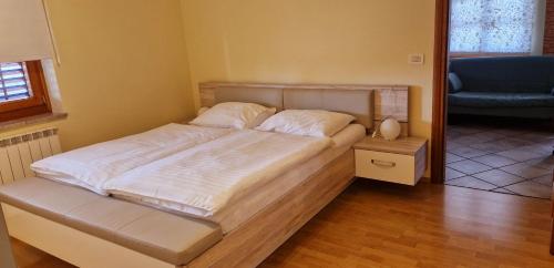 a large bed in a room with at Apartma Arkade in Črniče