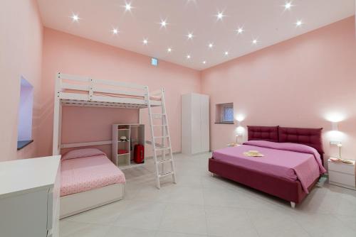 a bedroom with two bunk beds and a ladder at La Stella dei venti in Vico Equense