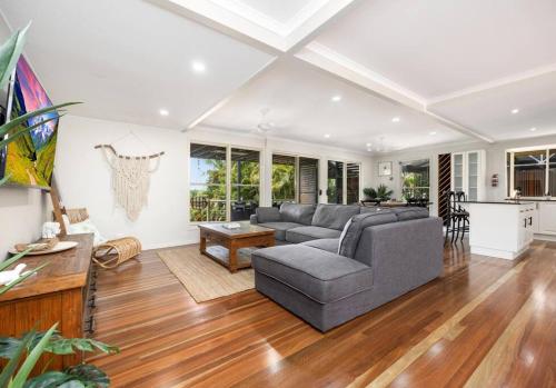 a living room with a couch and a table at Coco Palms in Hervey Bay