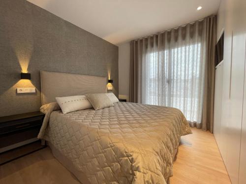 a bedroom with a bed and a large window at Bungalow Laumar - Jávea in Jávea