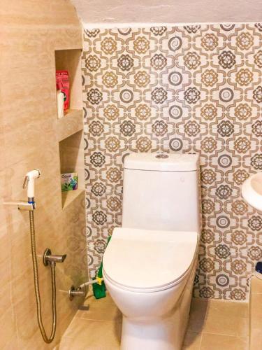 a bathroom with a toilet and a sink at The Melo pomelo courtyard. ( Right in between Thamel and basantapur durbar square) in Kathmandu