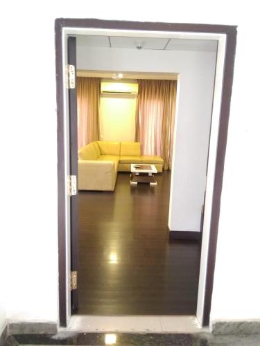 a view of a living room with a yellow couch at Crest Executive Suites, Whitefield in Bengaluru