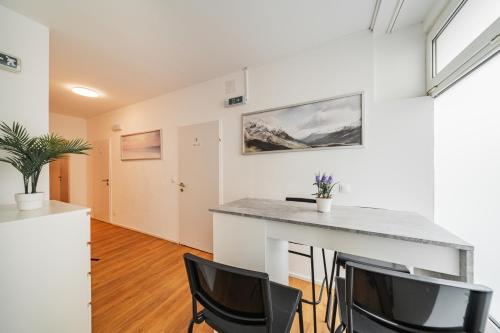 a kitchen with a table and chairs in a room at Central Apartment Lofts in Vienna