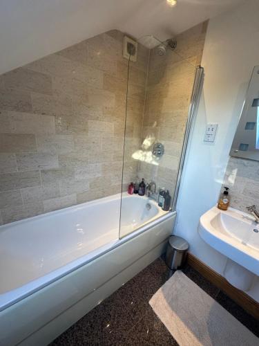 a bathroom with a shower and a tub and a sink at Royal Hillsborough Rural Retreat Siren Stays in Hillsborough