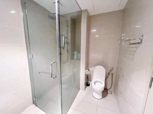 a bathroom with a toilet and a glass shower at [PROMO]Connected train 1 Bedroom (ABOVE MALL)6 in Kuala Lumpur