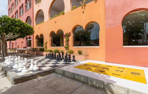 a chess board on a sidewalk in front of a building at Playacálida in Almuñécar