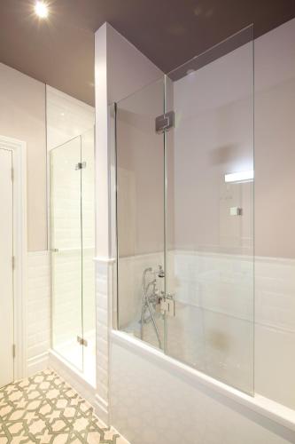 a bathroom with a shower and a glass shower stall at 8 Beresford Street in Saint Helier Jersey