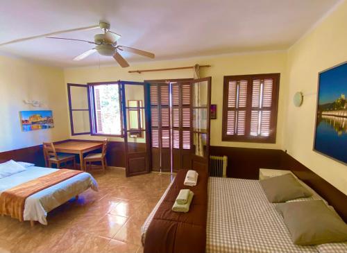 a bedroom with a bed and a desk and a table at Hostal Atlanta in El Arenal