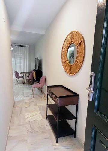 a room with a table and a mirror on the wall at San Clemente House in Seville
