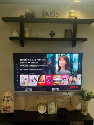 a flat screen tv sitting on top of a shelf at ADB Tower 1 bedroom with fast wifi and Netflix at Ortigas across Robinson's Galleria in Manila