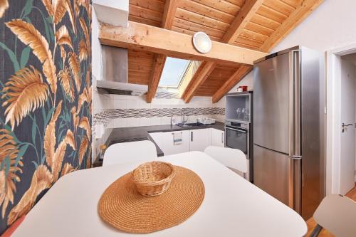 a kitchen with a table with a straw hat on it at Design apartment in Bratislava