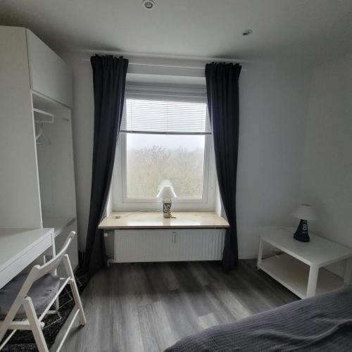 a bedroom with a window with a lamp on a desk at App Strandnest mit Meerbl mit Strandkorb am nahen Strand by Unsere Urlaubszeit in Grömitz