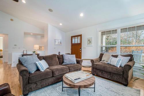 a living room with two couches and a table at Borrowed Thyme in Saugatuck