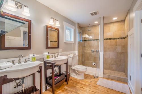 a bathroom with two sinks and a shower and a toilet at Borrowed Thyme in Saugatuck