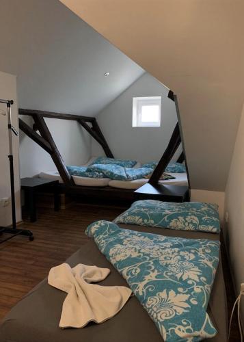 a room with two beds in a attic at Pension Sara in Hevlín