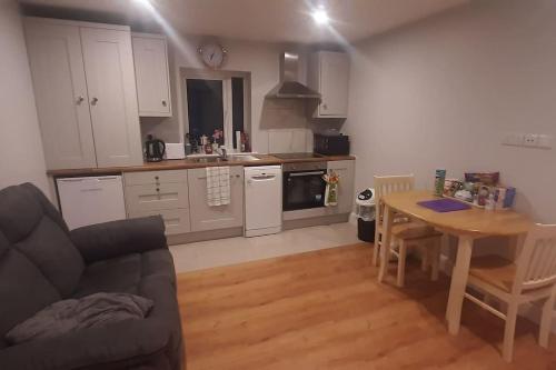 a kitchen with a couch and a table in a room at Swan Studio Haven in Lisdoonvarna