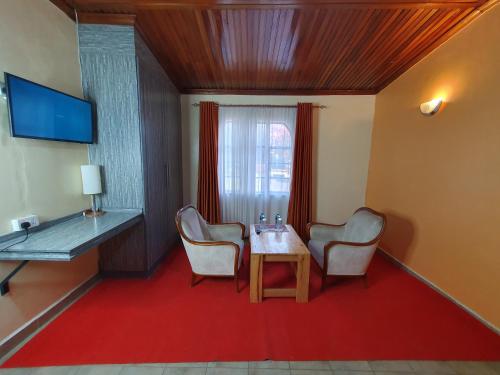 a room with a table and two chairs and a desk at Levels Hotel in Nairobi