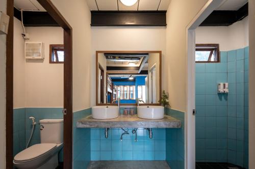 a bathroom with two sinks and a toilet at The Stage-Koh Chang in Ko Chang