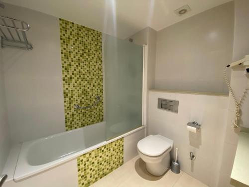 a bathroom with a toilet and a glass shower at BENALBEACH COMPLEX in Benalmádena