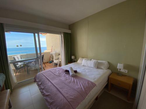 a bedroom with a bed with a view of the ocean at BENALBEACH COMPLEX in Benalmádena
